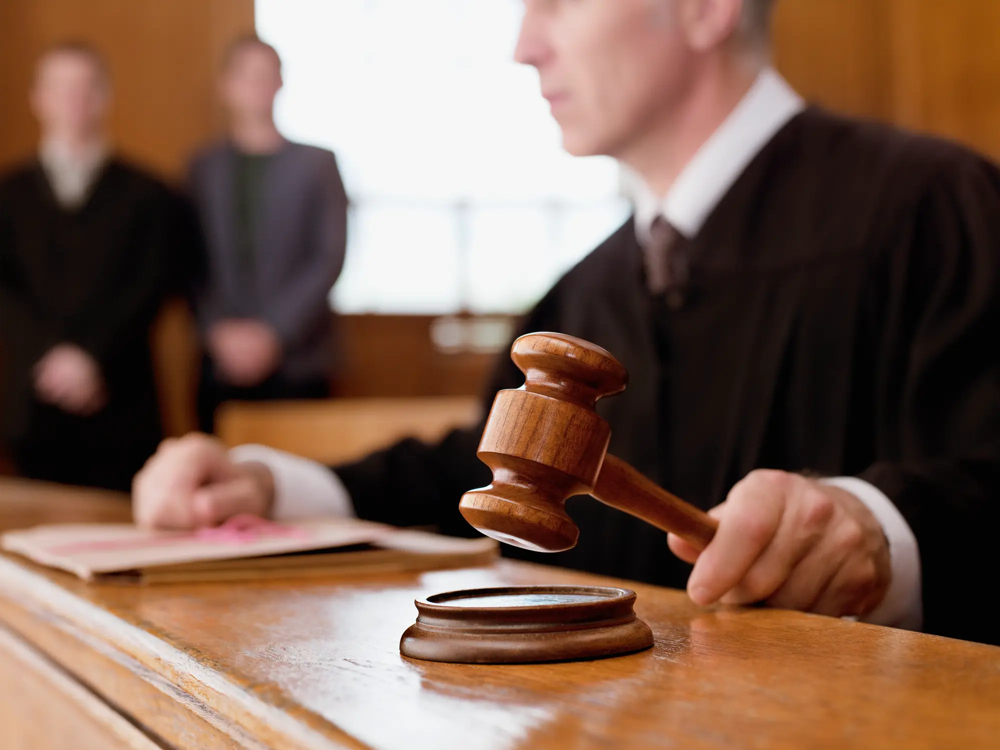 Male Judge in courtroom holding gavel